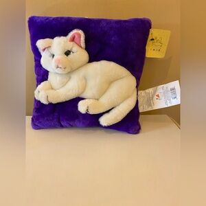 Plush White Cat on Purple Pillow